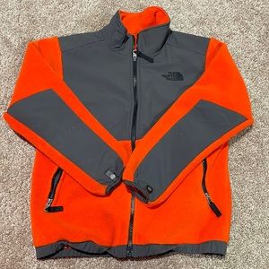 orange and grey north face zip up